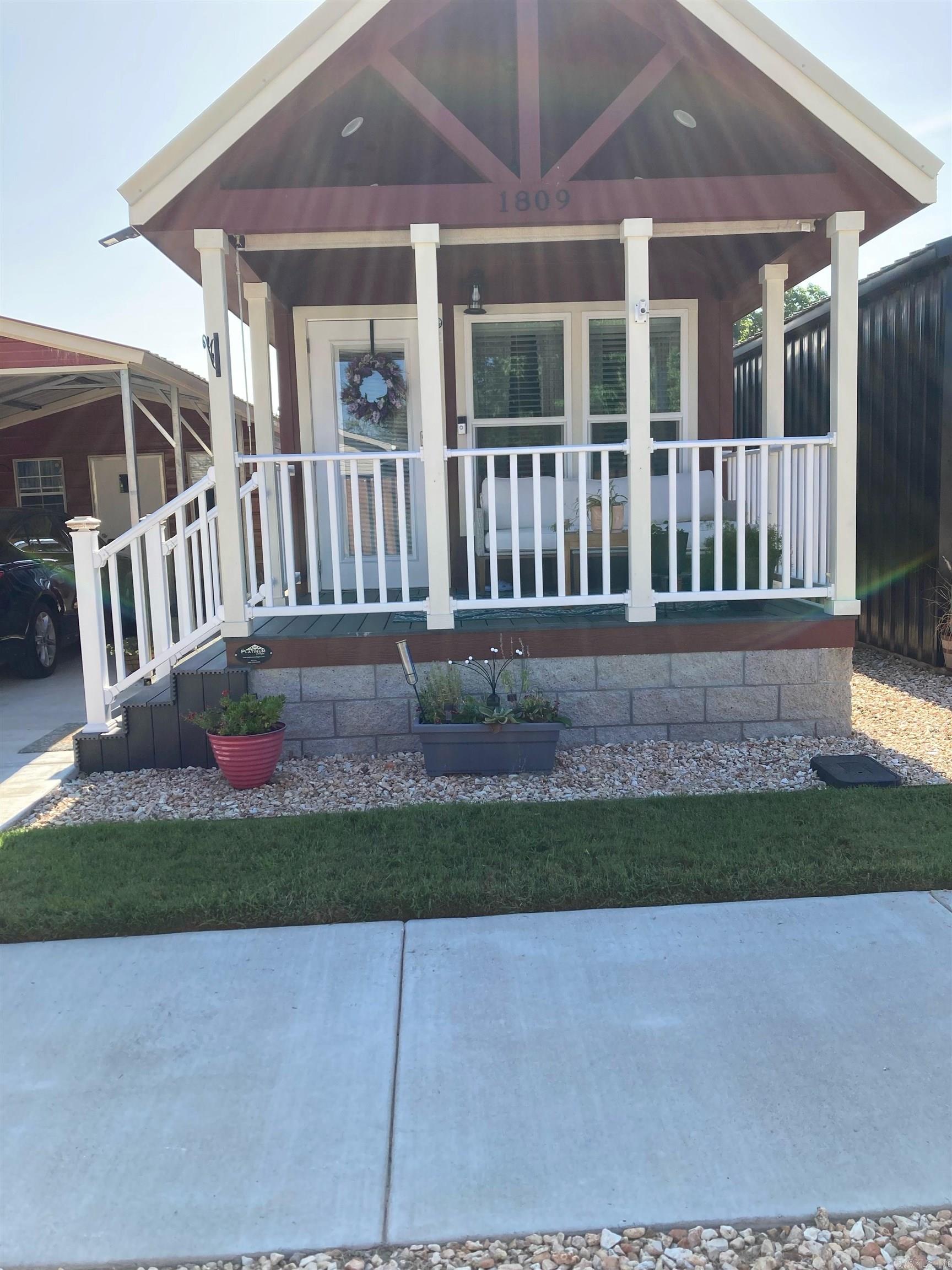 Welcome to your charming 2023-built tiny homeāa perfect blend of style, efficiency, and convenience in a peaceful Rogers community. This single-level, all-electric 1-bedroom, 1-bath home offers low-maintenance, low-cost living with quality upgrades throughout. Step onto the inviting front porch and into a thoughtfully designed interior featuring durable LVP flooring, window blinds, ceiling fans, double-insulated walls, and two energy-efficient mini-splits for year-round comfort. The kitchen shines with abundant storage and full-size stainless steel appliances, while the bedroom boasts dual closets with a built-in dresser for exceptional organization. All appliances conveyāincluding washer, dryer, and refrigeratorāmaking this truly move-in ready. Additional highlights include a metal roof, detached 350 sq. ft. storage building, and a metal carport. Enjoy the unbeatable locationāminutes from Downtown Rogers, shopping, dining, parks, schools, the greenway trail, hospital, and fire station. Must be owner-occupied; rentals not permitted.