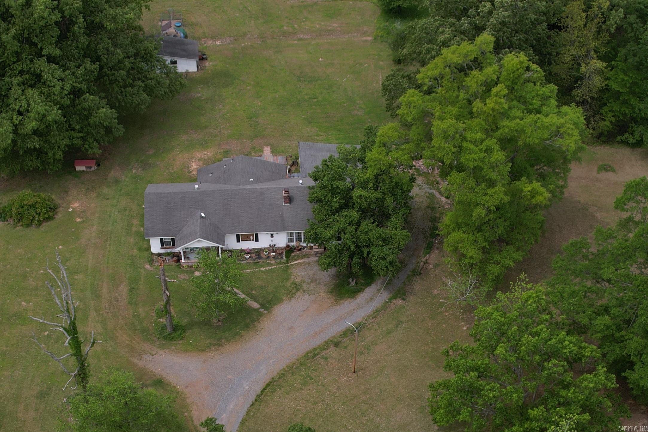 Beautiful, spacious house on 5.6 acres! Seller is offering a BUYER CREDIT of $11,000 or seller will install a NEW ROOF! In the country, but only 5 miles to interstate 530, near Glendale, located in the New Home community. Star City school district. House has been updated with newer appliances, vinyl plank flooring, and more. Extra large living room with wood burning and gas logs fireplace, large kitchen with lots of cabinets and a pantry, sunroom, 3 bedrooms are together, a hallway bathroom, and a primary bathroom, large laundry room, 2 car carport, and an outbuilding with chicken coup! HVAC new in 2024. Refrigerator, washer, & dryer stay.