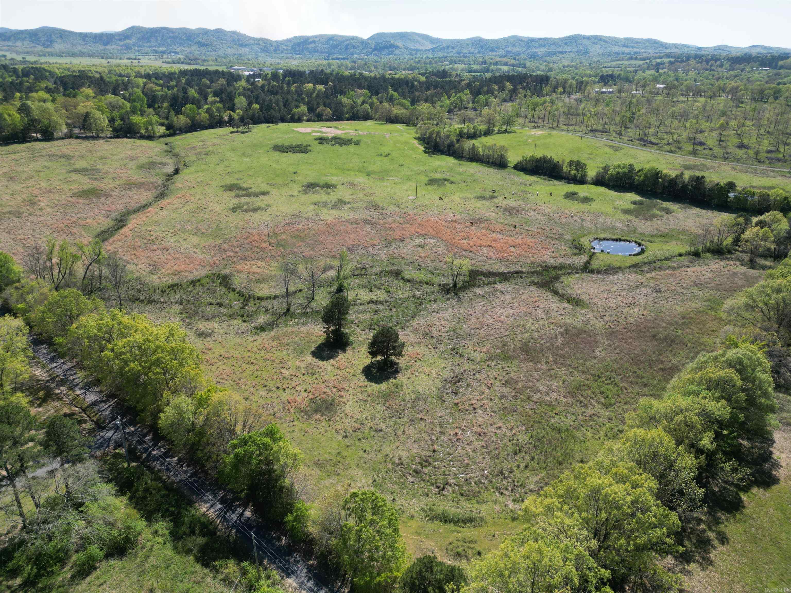 Looking for a place to build with stunning mountain views? This is it! This 40 +/- acre property not only has some gorgeous building sites, but also has two ponds and rural water already at the property. Other utilities available. Mobiles allowed. Near the airport. So much opportunity for development - lots of room for several homes.
