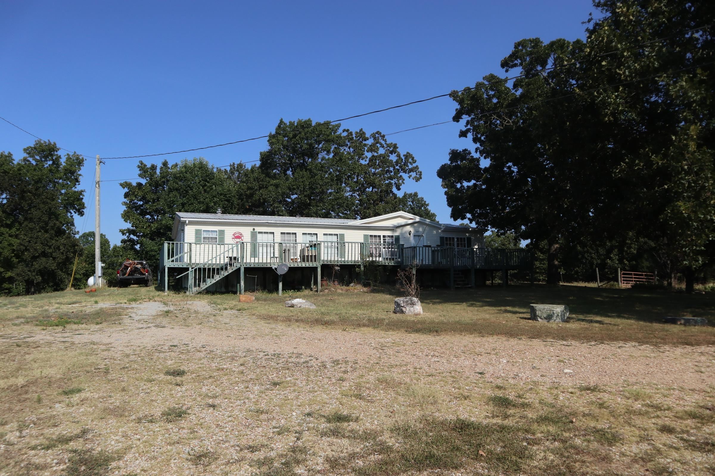 COUNTRY HOME AND ACREAGE FOR SALE NEAR SALEM ARKANSAS The 3 bedroom 2 bath mfg. home has approx. 1,792 sq. ft. of living area. The home has carpet and vinyl flooring, range, refrig., 2 gas wall heaters, window a/c, gas log fireplace. Also includes a large wood deck on the front of the home. It has rural water and private septic system. Great view from the front of the house. Small storage building. The house sits on 4 acres with highway frontage. Some repairs are needed. House being sold "AS IS". Most of the property is open with a small fenced in area for a few animals. Plenty of space for your garden. Lake Norfork, Spring River and the world famous White River are 30-45 minutes away. Real estate taxes last year were $351. Make your move to the Ozarks and enjoy all this property has to offer.