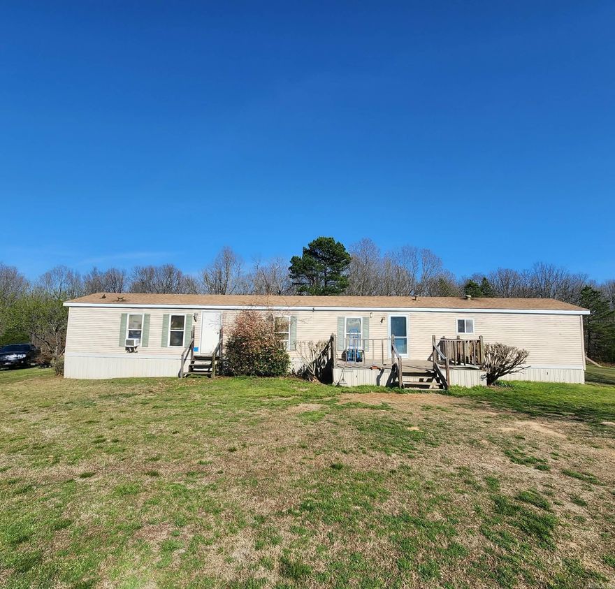 Private country living on a long dirt road to ride utv's or horses on, 3.8 acres completely fenced with gated entry, chicken coop, storage shed, shop, garden area, water everywhere needed, all usable land, home sits off road toward back of property.