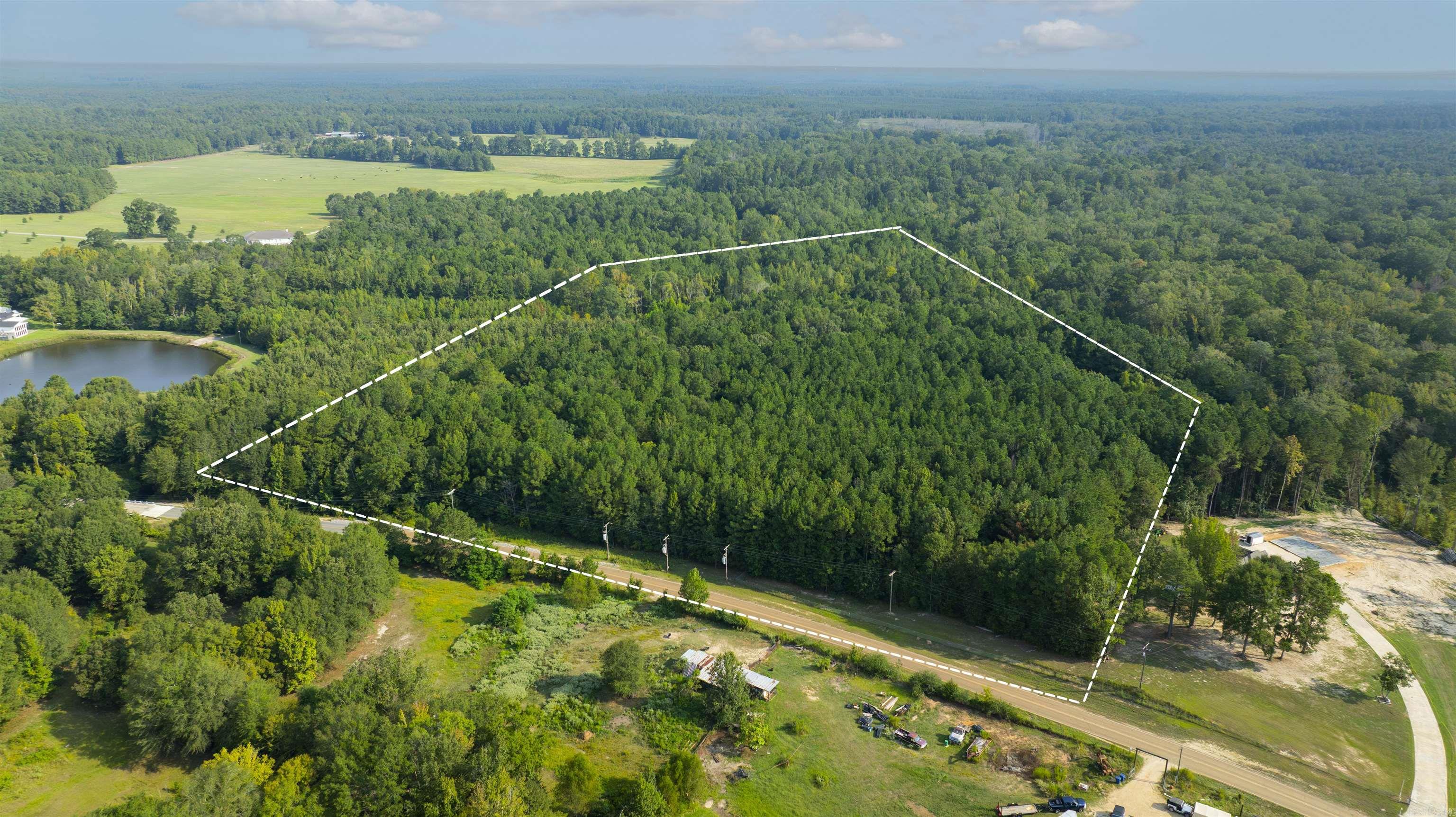 11.73 acres on Mt. Holly Rd. offers a great opportunity on the west side of El Dorado. This property features a mix of timber and natural beauty, with a creek running along the northwestern boundary that adds character and appeal. The setting is private and peaceful, and with its convenient location just minutes from town, you get the benefits of country space without being far from everything El Dorado has to offer. **Boundary lines shown in the aerial photos are for illustrative purposes only and are not exact. Property lines should be verified by survey and licensed surveyor.**