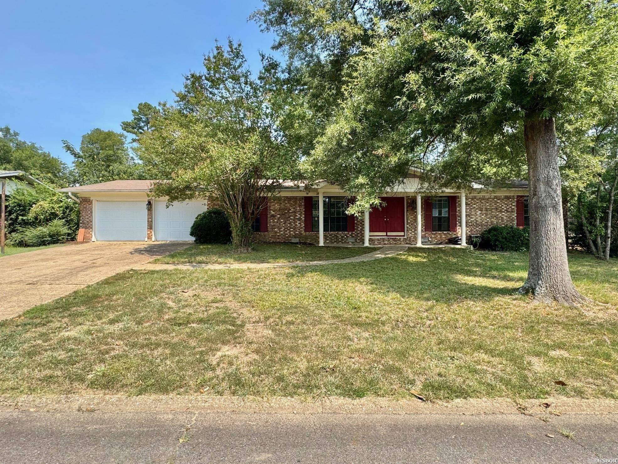 This well-maintained 3 bedroom, 2 bath brick home sits in a prime central location, just minutes from the hospital, shopping, and your favorite local restaurants. Inside, you'll find a spacious open floor plan with fresh paint, new vinyl plank flooring, and a cozy woodburning fireplace as the living room centerpiece. The kitchen and living areas flow seamlessly, while the primary bedroom offers a private bath for added comfort. Step outside to a large, fully fenced backyard with a covered patio. A two-car garage provides generous storage space, including a cedar-lined closet. One-level living in a convenient, established neighborhood—this one has it all!
