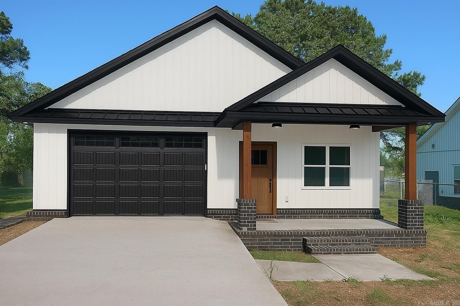 Beautifully crafted new construction home with easy access to Hwy 270! This modern gem offers curb appeal galore with sleek black and white exterior finishes, brick accents, and a welcoming covered front porch. Step inside to find an open and inviting layout featuring luxury flooring, custom lighting, and designer touches throughout. The kitchen is a true showstopper—equipped with stainless steel appliances, crisp white cabinetry, a stylish range hood, and quartz countertops. The bathroom includes a walk-in shower, vanity, and matte black fixtures for a contemporary touch. Outside you can enjoy the back porch and low-maintenance yard. Whether you're commuting, entertaining, or relaxing at home, this property delivers comfort and convenience in one smart package.