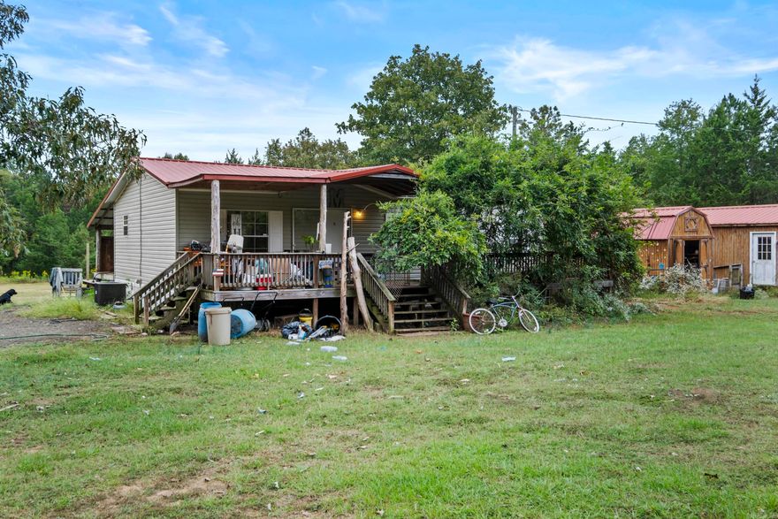 Looking for peace and quiet! This Property offers it all! 2 live streams on the property. 12.09 (+/-) acres with Atv trails to ride on! Covered front and back Porch to sit out on drinking your coffee and watching the wildlife! It would be a perfect match for a hunting lodge, or turning into your dream home! Large storage building conveys with the property! Seller States mobile is on a permeant foundation.