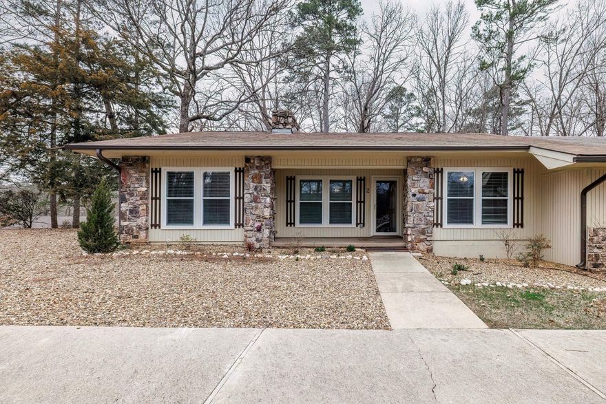 What a find!  This 3 bedroom 2 bath ONE LEVEL townhome is sure to please! Spacious living room with fireplace and dining area opens to Arkansas room for year-round enjoyment.   Kitchen with breakfast bar, more than ample counter and storage space.  Split bedrooms.  On the right when you enter is the master bedroom with full bath and walk in closet.  On the left two bedrooms with a Jack & Jill bath.  Back bedroom opens to Arkansas room.  Updates include roof 3 years new, windows are 3 years new, LVP is 3 years new.   The Heat pump was installed in 2023 .  Arkansas room and deck are 3 years new.  This home is located in popular Madrid Courts.  This would make a great primary home, or vacation home.   As your vacation home you could use as a nightly rental when you are not present.  Move in ready, clean, newer window treatments, all appliances.   Some pictures are of Hot Springs Village amenities not just this home.