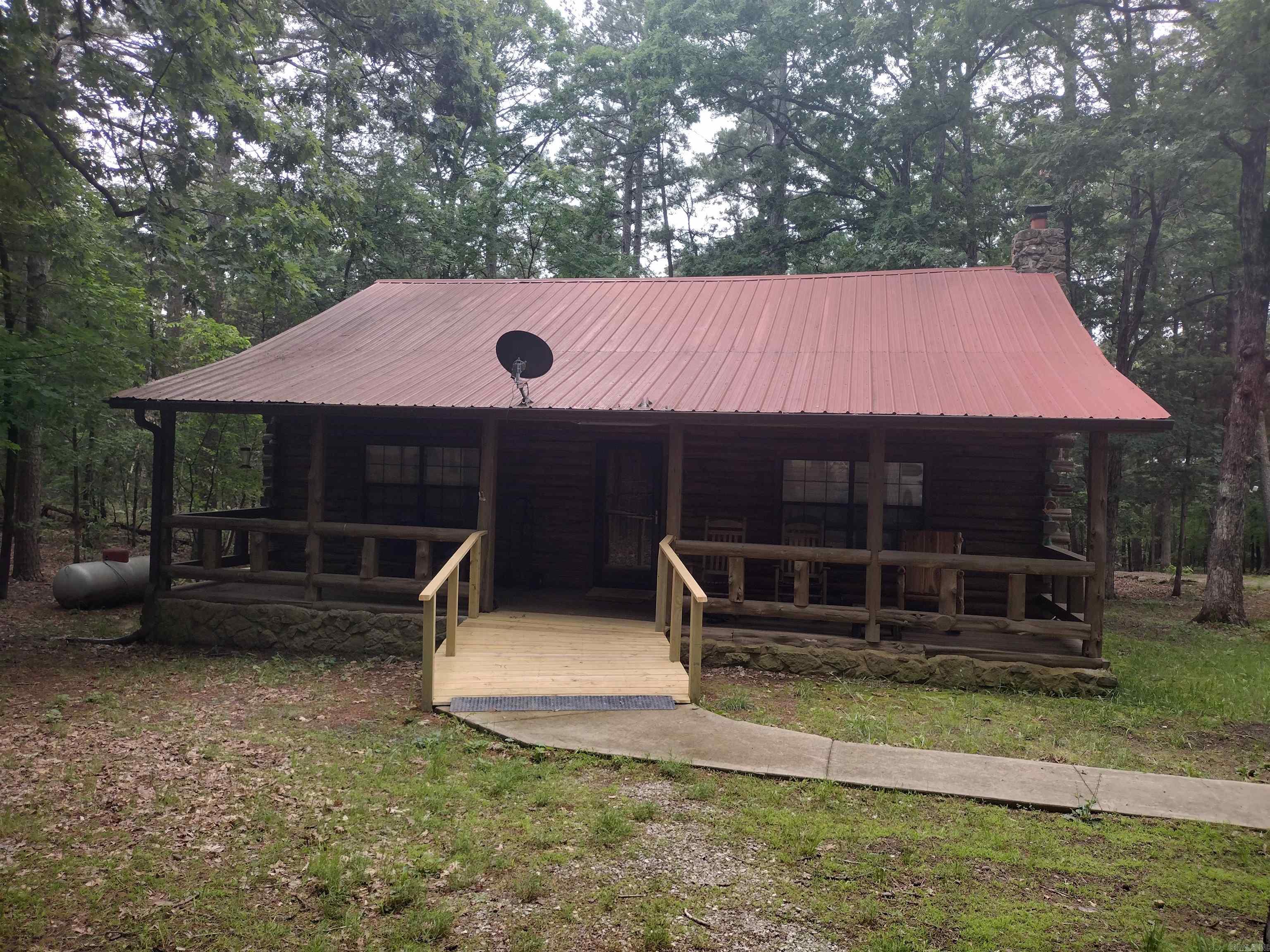 Escape to the woods, and unwind in this cozy ceder log cabin, featuring a expansive front porch. The cabin boasts 2 bedrooms and 2 Bathrooms, and a loft that can be utilized as an additional bedroom. Also includes whole house generator that's 1 year old. Abundant wildlife on this 5.62 acres and conveniently located conveniently located approx. 10 minutes from Mountain View AR.