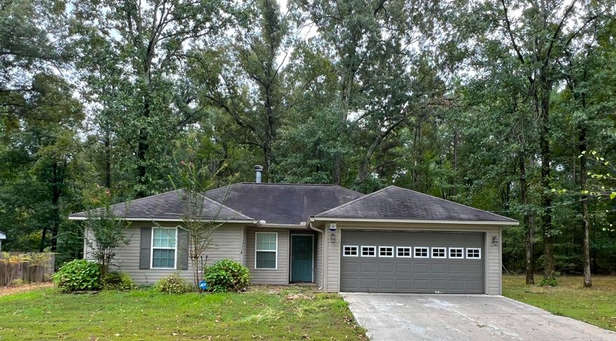 This beautifully updated 3-bedroom, 2-bathroom home offers 1,329 sq ft of move-in ready comfort. Featuring new flooring, fresh paint, and stylish cosmetic upgrades throughout, the home boasts a split floor plan and a cozy wood-burning fireplace. The master bedroom includes a spacious walk-in closet, and the private laundry room adds convenience. Enjoy outdoor living with a large covered back deck, perfect for entertaining, all situated on a 3/4-acre lot. The ADT security system conveys with the property for added peace of mind.