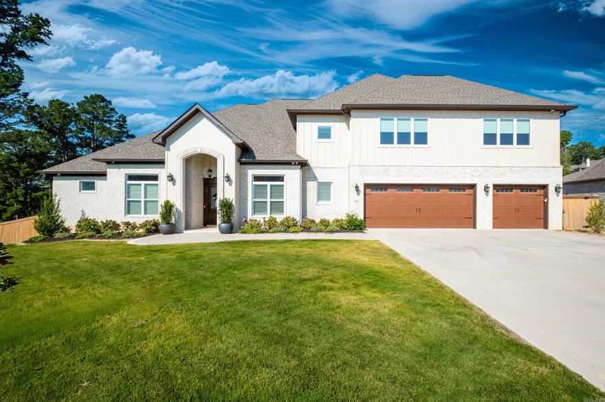 This exquisite home built in 2023 is settled on a level lot at the end of a cul-de-sac overlooking greenspace & a valley view. 5 beds/4.5 bath smart home features 10’ ceilings, plantation shutters & automated window coverings. Main level has office, dining, 3 bedrms, includes primary, 2 full baths & powder rm. All soft-close cabinets/drawers. Living rm w/ wood cathedral ceiling, gas FP & wired for surround sound w/ in-ceiling speakers. Pull-down TV mount over FP. Kitchen boasts ample counters w/ bar seating & island. Induction cooktop w/ professional-grade vent, Café Line double ovens, farmhouse sink (+ prep sink), ss fridge, drawer microwave & pantry. Primary suite features double tray ceilings, sitting area, bath w/ vanity seating, heated tile floors, claw tub, shower w/ dual heads & lrg walk-in closet w/ 2 built-in chests of drawers. Guest rooms connected by J&J bath w/ heated floors. Laundry has full-size fridge, cabinets/storage. Upstairs is living area & sunrm, lrg storage rm, 2 bedrms/2 baths. Covered patio has outdoor kitch w/ gas grill/side burners. Generator, ext cameras, spklr systm & programmable holiday lighting. 3-bay OVRSZD garage & EV charger. See attached features.