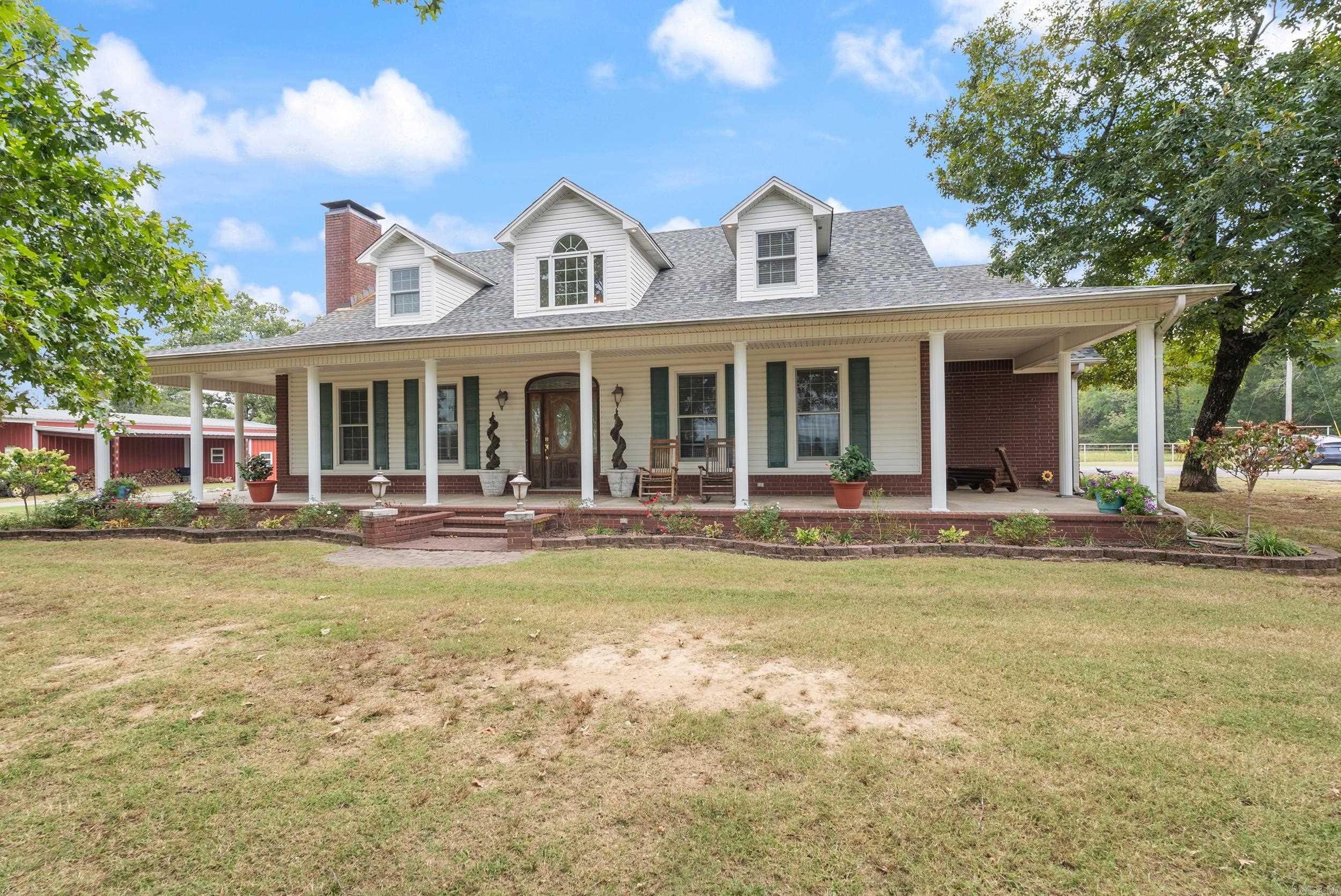 Welcome to this stunning country estate featuring nearly 3,500 sq. ft. of heated and cooled living space and almost 5,700 sq. ft. under roof. Situated on 20 +/- beautiful acres, this property offers the perfect blend of luxury, functionality, and breathtaking views. This spacious 4-bedroom, 4.5-bath home has been exceptionally maintained and offers comfortable living with room for everyone. The home features a newer roof, thoughtful design, and plenty of space for entertaining or relaxing. Outside, you’ll find everything you need for work, play, and storage: 30’ x 50’ shop with bathroom, gas heat, and two 16’ x 50’ lean-tos on each side. Apartment within the shop, ideal for guests or extended family. Large hay shed/extra barn for agricultural use or equipment storage. Pipe fencing surrounding the property for durability and beauty. Whether you’re enjoying the sweeping views, working the land, or hosting gatherings, this property offers endless possibilities. Don’t miss your chance to own this remarkable slice of Arkansas countryside! OWNER FINANCING IS AVAILABLE!!!