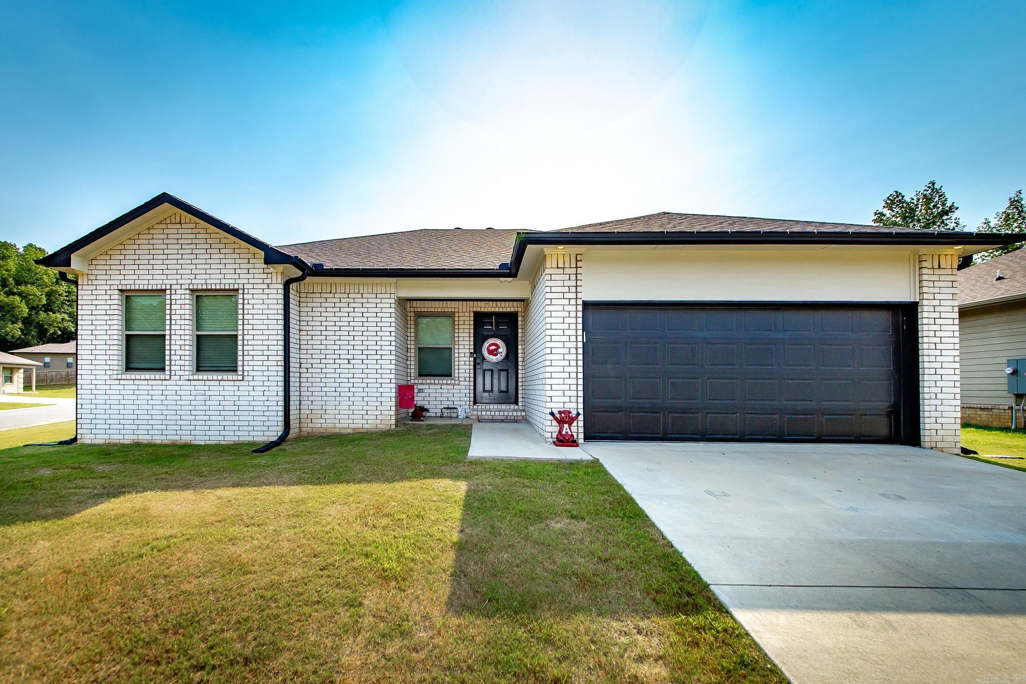 Pulling up to this charming home on a large corner lot, youāre immediately drawn to the timeless white brick and siding with bold black accents. Step inside and be greeted by luxury vinyl plank flooring that flows seamlessly into the ope-concept living area with tongue and groove wood ceiling accent. The living room offers a bright and welcoming space with a clear sight to the kitchen and dining room comboāperfect for entertaining. The kitchen features sticking black cabinetry, sleek butcher block counter tops, and stainless steel appliances, creating a modern yet cozy feel. Off the living room, step through to the covered back porch for relaxing evenings or weekend gatherings. This split floor plan offers a private primary suite with a spacious bathroom and walk in closet, while two additional bedrooms and a full bathroom are tucked on the opposite side for comfort and convenience. With its stylish design, functional layout, and inviting outdoor space, this home is ready for you to move right in and enjoy!