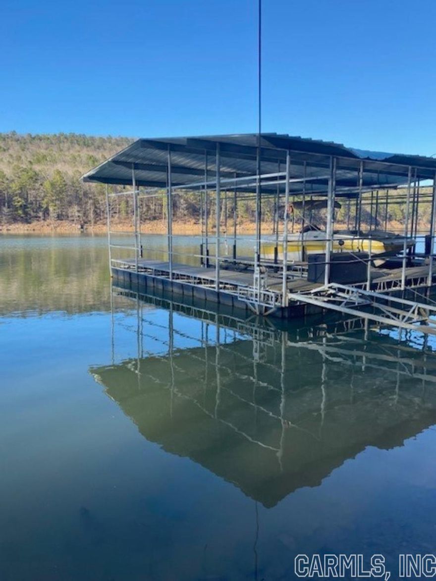 LAKEFRONT WITH BOAT STALL, BOAT LIFT AND A REALLY NICE 5TH WHEEL RV. great setup with a great view of the lake. Property large enough for a few more RV's or building a cabin.  Launching ramp located near by.  Located at the end of Macleod means no thru traffic and privacy. 5th Wheel is 2005 "Alpha See Ya", 34 footer, large BR, sleeper sofa, full furnished (no dishes, pots or pans) has a wash machine, everything very neat and clean.  Set of rock steps to the dock located on the left side of RV if facing it.