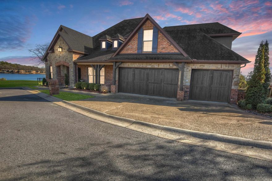 Captivating 3,839 sq ft waterfront home by Carriage Custom Homes offers panoramic Lake Hamilton views. The dramatic foyer with stained wood barrel ceiling and meticulous wood trim sets the tone for this masterpiece. Walls of glass lead to a spacious deck with walk-out access. The open concept floor plan features a vaulted beamed living room with a gas fireplace, a well-appointed kitchen, and a formal dining area. The primary suite boasts a triple trayed ceiling and a luxurious bathroom. Additional highlights include a 325 sq ft upper floor bonus room, covered patio, Trex decking on decks and boat slip, three-car garage, and a fenced backyard. Enjoy privacy in the cul-de-sac location on the point lot. No HOA fees. An exceptional blend of elegance and functionality awaits in this lakefront retreat.