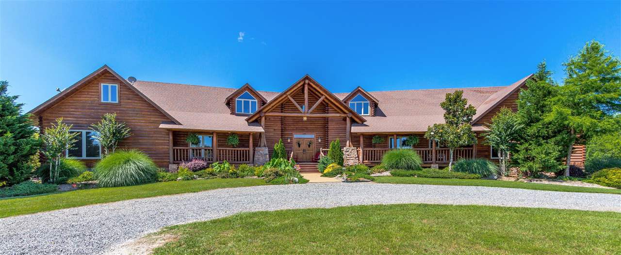 Have your very own private retreat! This gorgeous 4 BR 4.5 bath custom built Tidewater Red Cypress log home has many intriguing & high quality features throughout, lots of windows with gorgeous views, a loft, finished basement with a media room & screened-in porch off of the master with a swing & hot tub. Enjoy the seclusion 30 acres offers backed up to the National Forest with extra landscaping, a creek, stocked catfish & brim pond, shop, sports court, fire pit & salt water pool. You won't want to leave.