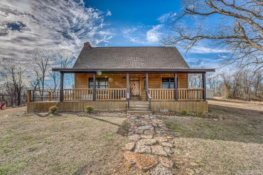 Walnut View Cabin is a proven income-producing property set on 4 scenic acres near Ponca and Deer, Arkansas, just minutes from the Buffalo National River, Glory Hole and Paradise Falls trailheads, and 10 miles from Boxley Valley. Perched on a knoll overlooking Walnut Valley and the Ozark National Forest, it offers privacy, easy access at the junction of AR-16 and AR-21, and ample parking. The log-sided cabin features a large wraparound deck, towering brick fireplace, and outdoor firepit with incredible star-filled views. Inside, the 2-bedroom, 2-bath layout includes vaulted ceilings, native pine accents, expansive windows, and an open kitchen with custom oak cabinets and granite countertops. The main level offers a bedroom, bath, and laundry, while the loft includes additional living space, a second bedroom, bath, and storage. Ideal as a turnkey rental, private retreat, or full-time residence in one of Arkansas’ premier outdoor destinations.