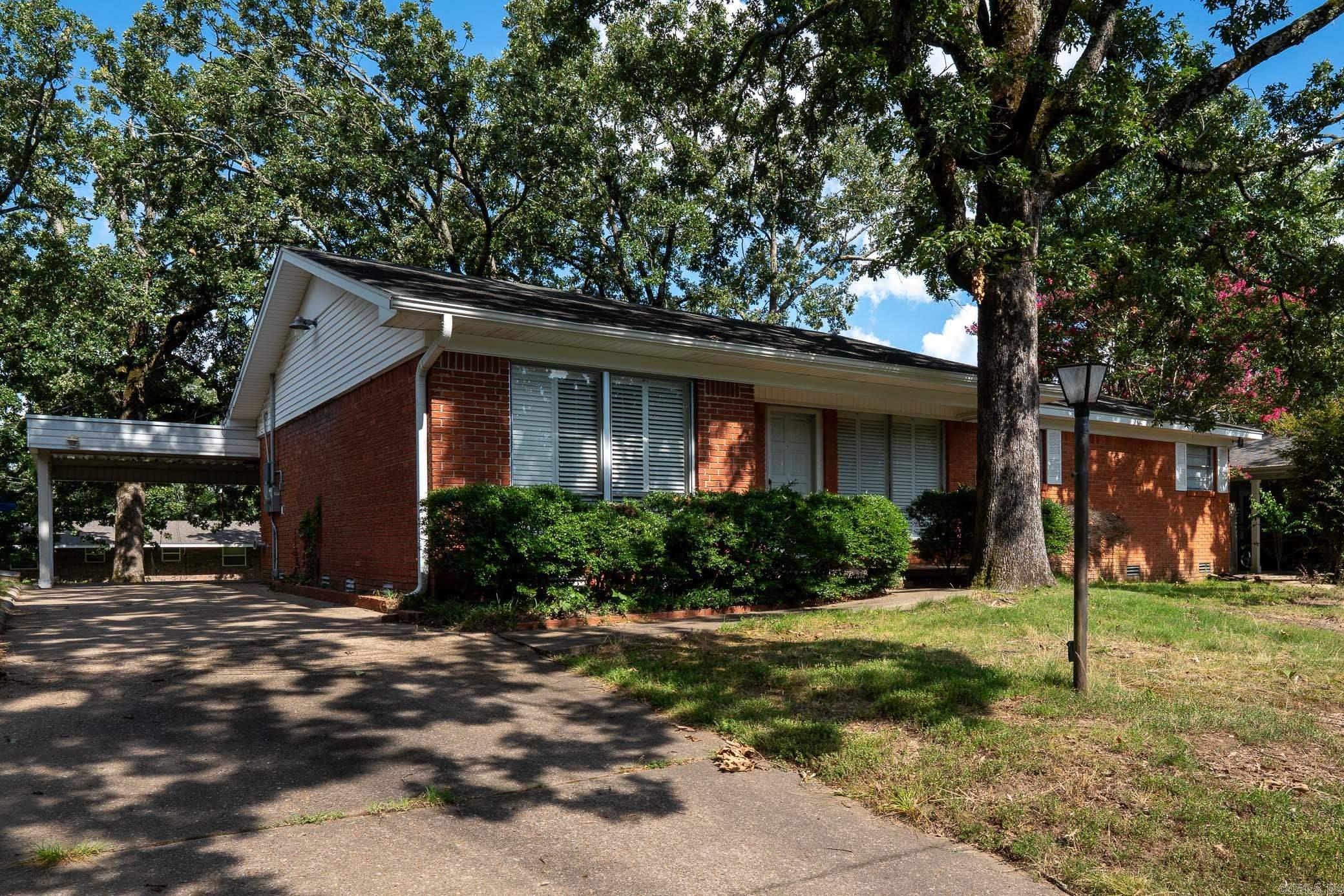 Welcome to 5104 North Cedar, located in the desirable Park Hill subdivision of North Little Rock. This beautifully updated one-level home offers 3 bedrooms, 2 full bathrooms, plus a spacious bonus area and a light-filled sunroom—providing versatile space for work, play, or relaxation. Inside, you’ll find a thoughtful blend of modern updates and original charm. The kitchen features granite countertops and tile flooring, while the bonus room and sunroom also showcase stylish tile finishes. Fresh paint throughout and original hardwood floors in the main living areas and bedrooms give the home a warm, inviting feel. The large bonus room is perfect for a second living area, home office, or media space. Enjoy your morning coffee or unwind in the cozy sunroom overlooking the backyard. Outside, there's extra parking with a carport and an additional storage area that’s ideal for a workshop or hobby space. The fenced backyard offers great outdoor potential for entertaining or relaxing. Located just minutes from downtown, shopping, schools, and parks, this move-in ready gem in Park Hill is ready for its next chapter. Don’t miss it—schedule your private showing today!