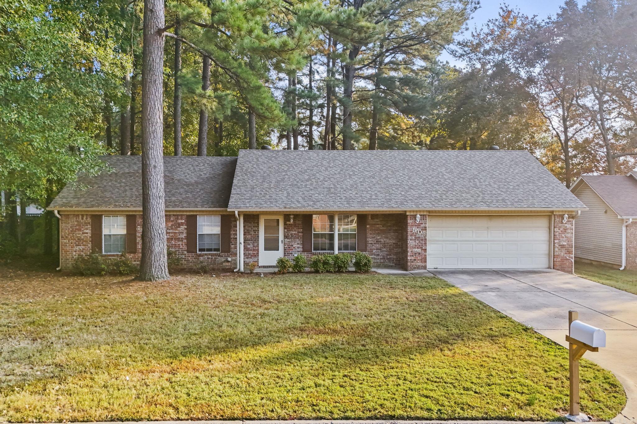 Welcome to your dream home! Convenient location near restaurants, shops, central elementary, and a grocery store. This inviting, all brick 3-bedroom, 2-bathroom residence combines comfort and style, perfect for families or anyone seeking a serene retreat. Step inside to find a cozy living area featuring a beautiful corner fireplace.  You will love having laminate floors throughout!  The large laundry room adds convenience to your daily routine, making chores a breeze with all the extra storage, & built-in ironing board. Outside, the backyard offers a covered porch, and an attached deck space that is perfect for entertaining, or enjoying morning coffee, while overlooking the spacious yard with mature trees to enjoy nature.  New roof-2024.  AC unit is 5 years old and gets scheduled maintenance service. This home sits in a cul-de-sac, so no through traffic!!  This home is to be sold "AS IS".  Sellers are negotiable!!