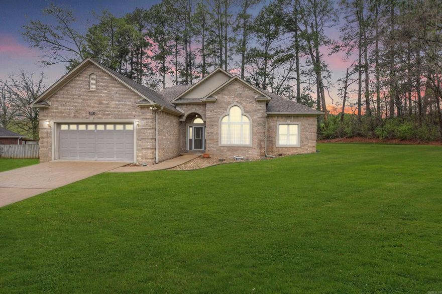 This brick, one-level home in the Shady Woods neighborhood of Hot Springs offers the perfect blend of convenience and accessibility. Located in the heart of the city near shopping, dining, and medical facilities, the residence features a thoughtful universal design, including a no-step entry and a spacious, open-concept layout. The central living area—comprising the family room, dining room, kitchen, and breakfast nook—boasts vaulted ceilings and a cozy fireplace.  The primary suite is a true retreat with a large walk-in closet and an ensuite bath featuring grab bars and a taller toilet. Recent updates provide peace of mind, including new flooring throughout (2020), updated kitchen cabinetry and quartz countertops (2020), and a new dishwasher and disposal (2025).  Practicality meets privacy outdoors with a double car garage containing a dedicated workshop/storage room and a small fenced backyard that backs up to a serene line of woods. This move-in-ready home is ideal for those seeking a low-maintenance lifestyle without sacrificing modern style or a prime location.