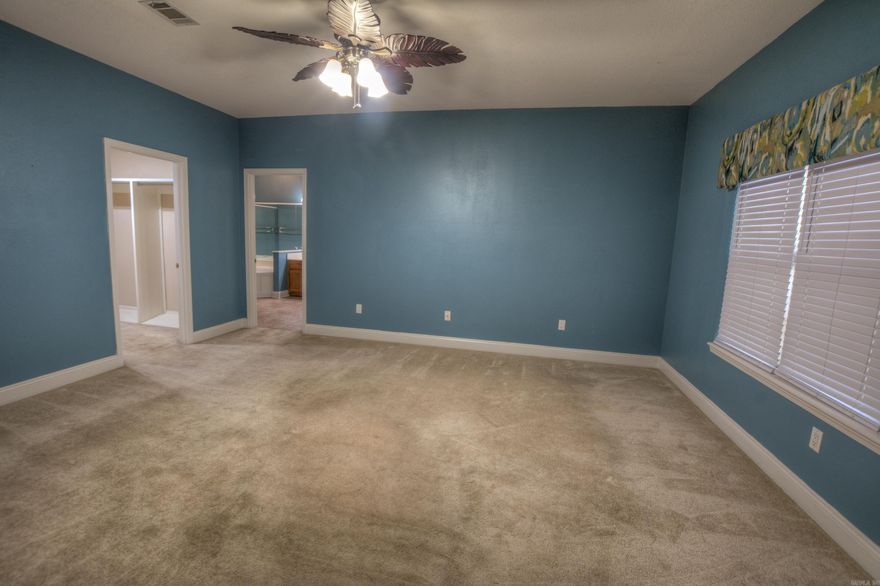 This brick, one-level home in the Shady Woods neighborhood of Hot Springs offers the perfect blend of convenience and accessibility. Located in the heart of the city near shopping, dining, and medical facilities, the residence features a thoughtful universal design, including a no-step entry and a spacious, open-concept layout. The central living area—comprising the family room, dining room, kitchen, and breakfast nook—boasts vaulted ceilings and a cozy fireplace.  The primary suite is a true retreat with a large walk-in closet and an ensuite bath featuring grab bars and a taller toilet. Recent updates provide peace of mind, including new flooring throughout (2020), updated kitchen cabinetry and quartz countertops (2020), and a new dishwasher and disposal (2025).  Practicality meets privacy outdoors with a double car garage containing a dedicated workshop/storage room and a small fenced backyard that backs up to a serene line of woods. This move-in-ready home is ideal for those seeking a low-maintenance lifestyle without sacrificing modern style or a prime location.