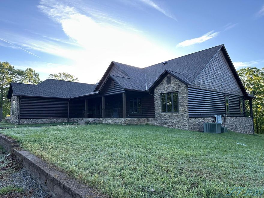Set on 186± acres of rolling terrain and mature mixed hardwoods, this legacy estate also features a 6,000 sq. ft. (4,600 sq. ft. heated/cooled) luxury log home with incredible craftsmanship and custom details throughout. Built in 2007, the home offers 3 bedrooms, 3.5 bathrooms, and spacious living and entertaining areas designed for comfort and style. Interior highlights include oak plank flooring, pine walls and ceilings, massive exposed cypress beams, and lodge-style lighting. The vaulted great room features a striking floor-to-ceiling stone fireplace. A gourmet kitchen includes Viking appliances, quartz countertops, Alderwood cabinetry, a large island, and a walk-in pantry. Additional spaces include a formal dining room with built-in china cabinets, a private office with a second fireplace, and an expansive master suite complete with a copper soaking tub, walk-in shower, and a large custom closet with integrated laundry. Upstairs, a spacious game room adds versatile living space. The home is also equipped with a central vacuum system, front and back covered patios, an attached garage with an oversized parking pad, and a paved driveway with electric gate access.