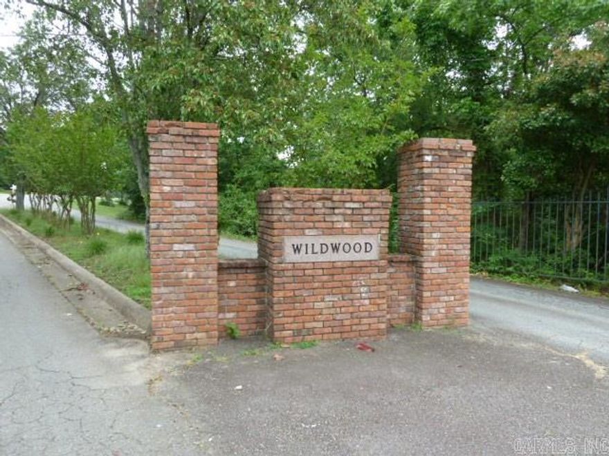 Sloping wooded lot in great neighborhood.