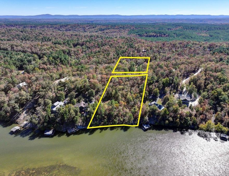LAKEFRONT LAND! This property is split into two main sections by Woodview Lane, which runs through the middle.  The Northern half of the lot borders Lake Hamilton with 213 front feet of shoreline, offering scenic views and access to the water.  This part could be ideal for a new home site (there's a 1,000 Gallon Septic tank already in place), a private 2 stall boat dock can be permitted through Entergy and much more.  This side also has a 560 sq ft metal storage building in place closer to the road.  On the Southern half of the lot, separated from the waterfront by Woodview Lane, sits the ADU (Previous home) which is surrounded by a wrought iron fence and secured with a gated entrance. Although this half doesn't have a lake view, it has the makings of a beautiful water feature. The Tiki Hut creates an ideal spot for outdoor gatherings or relaxation. The ADU on the property could be used for living while building on North side. There's a wooden storage building (100 sq ft) and boat storage already on the property.  Both sides of this lot offer unique potential for extra home sites and more.