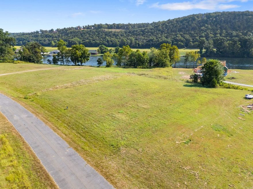 Welcome to Lot 32 in Denton Ferry Bottoms, a rare opportunity to own approximately 0.88 acres overlooking the legendary White River in the peaceful river town of Flippin. This gently sloping homesite o ers beautiful river views and the perfect setting to build your dream home, weekend getaway, or investment property in one of North Arkansas’s most desirable outdoor recreation areas. Located just minutes from Bull Shoals Lake and surrounded by the natural beauty of the Ozark Mountains, this property places you in the heart of some of the best trout fishing in the country, along with boating, kayaking, hiking, and wildlife watching right outside your door. The White River is world-famous for trophy brown trout, drawing anglers from across the nation. Denton Ferry Bottoms is known for its relaxed atmosphere, scenic views, and proximity to river access points, making it a favorite for those who want the Ozark lifestyle without sacrificing convenience. Just a short drive away you’ll find the shops, restaurants, and medical facilities of Mountain Home, while still enjoying the peaceful charm of small-town living.