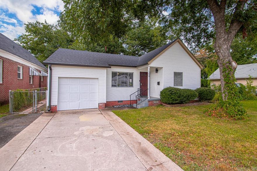 Ready to be called home! Charming front! Side walk, mature tree, and extra wide drive-way lead up to the one-car garage and covered front steps. Inside you'll find beautiful original wood floors! This layout feels larger than the square footage of home with a separate space for dining. Well preserved features from the 1940s with updated light fixtures. Cute built-in for your living room storage. Fresh paint. BRAND NEW ROOF with gutters and 200 Amp ELECTRIC PANEL to give you peace of mind!! Wired for Alro security system! Laundry hook-ups in the garage. Floored attic. Large back yard with pecan trees, fence, and shed. Great opportunity rather you're looking for your home or for a rental property.