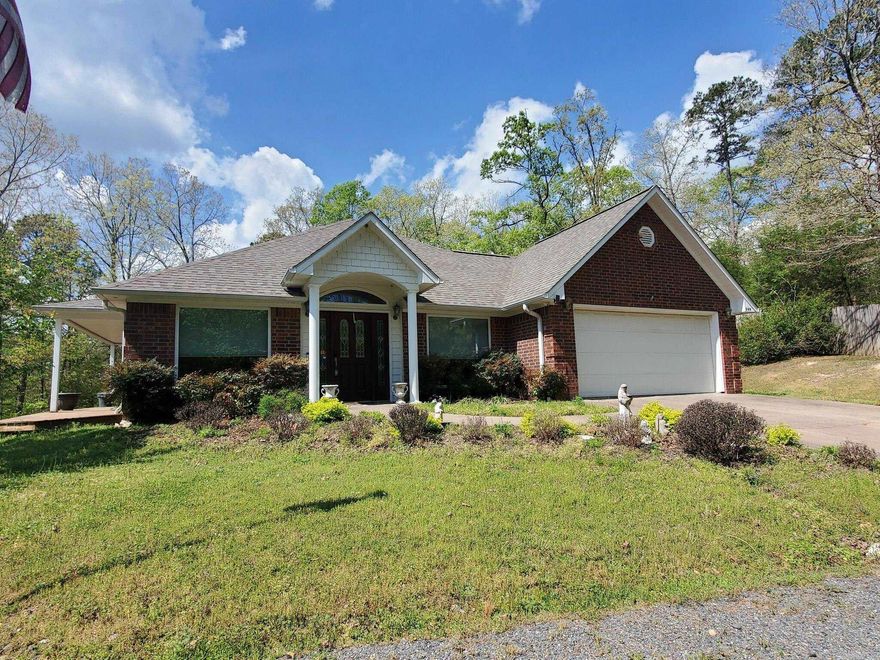3-bedroom, 2-bath brick home on approximately 18.25 wooded acres on a paved road just a short drive from Mena, offering pretty scenic vista views. The interior provides both a comfortable living room and a large great room with a cozy gas fireplace, plus a roomy kitchen with breakfast bar, plenty of cabinetry, pantry, and a separate formal dining room for gatherings. The main bedroom suite includes double vanities, a jetted tub, separate walk-in shower, and a large closet, and the big windows throughout the home bring in natural light and showcase the surrounding land. Outside, you can relax on the front porch or side deck while enjoying the setting, and you’ll also appreciate the oversized attached garage, an 18' x 24' metal storage shed, and a 24KW whole-home generator for peace of mind during outages. This property is a nice option for buyers who value privacy, wooded acreage, and room to roam while still being convenient to town services.