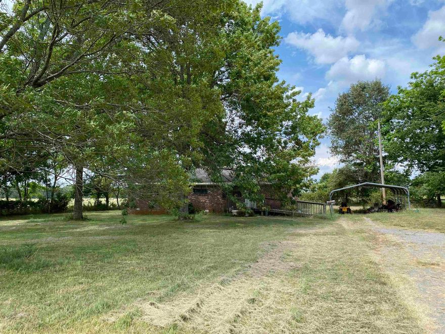 Brick exterior, 1 level home on 1 acre lot, den, 2 bedrooms, 1 bath, laundry, kitchen & dining room. Home sold "As-Is" no utilities on, would require cash or conventional loan. Composite roof. Needs to be cleaned out- all possessions convey.  See showing remarks.