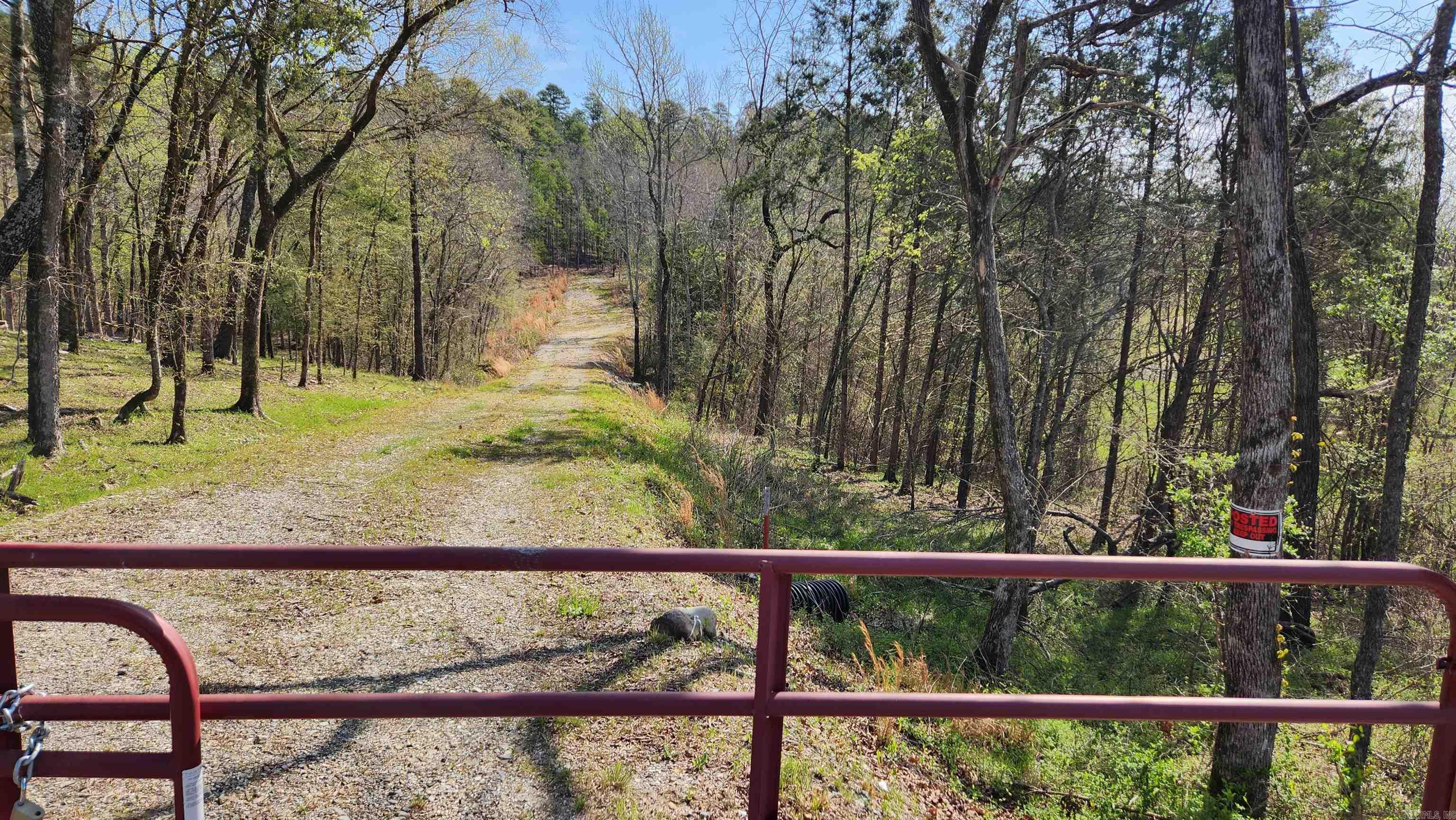 I know some of you do not like the word "subdivision". This property is in a "subdivision" that borders Ouachita National Forest on 3 sides and everyone in this area has access to Irons Creek. The owner has completed some of the prep work. A gate, road tiles, a road built (has a good base), pad for a work shop, pad for a house, 3 RV pads with hookups, septic (1000 gallon tank), a well, underground power (430 amp service), and 2 night lights. Did I mention that this 6.94 acre tract with a stocked pond also joins Ouachita National Forest on the east side? Evidence of deer activity and there were ducks on the pond. Mountain view. Mineral rights convey. Only minutes to Lake Ouachita.