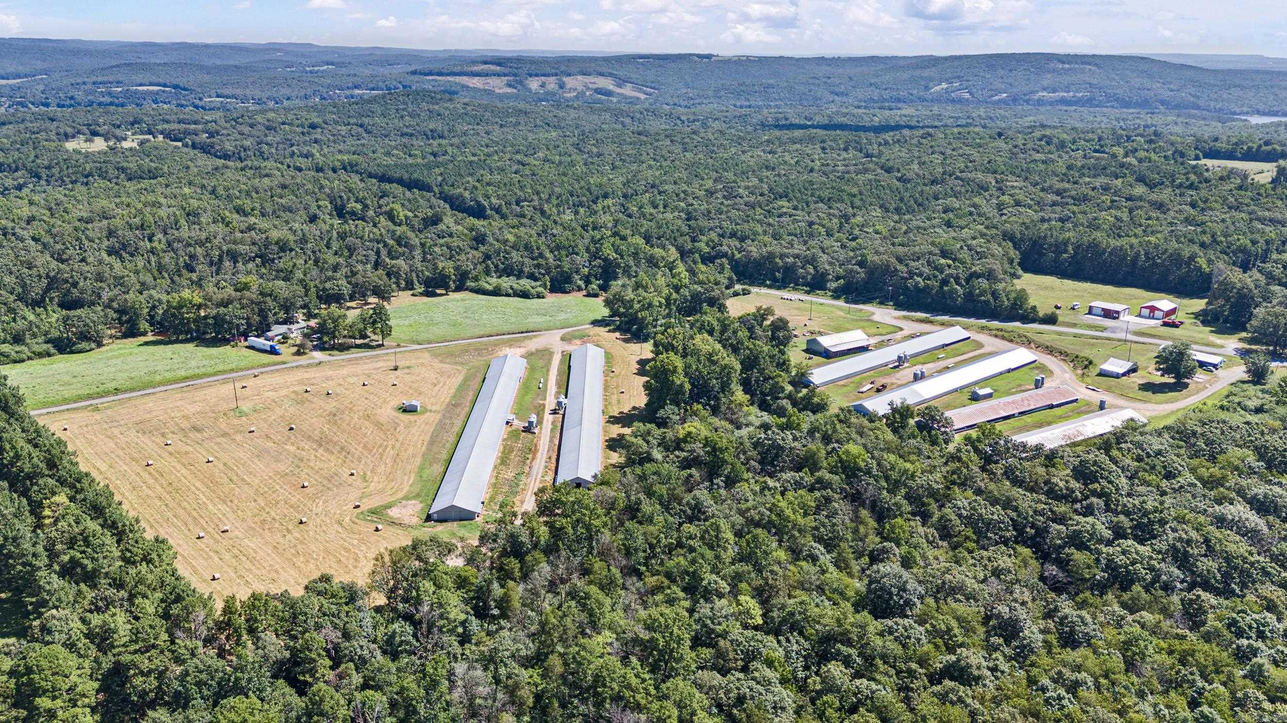 Tyson-Contracted Broiler Farm – Clinton, AR This well-maintained poultry farm sits on 23.50± acres and includes a strong Tyson contract. The operation features (2) 43’x375’ broiler houses and (2) 43’x500’ broiler houses, a 40’x90’ litter shed, a 30’x40’ shop, and two additional older houses currently used for hay storage. A prime hay meadow adds even more value and versatility. The property also includes a mobile home, perfect for full-time living or housing a hired hand. With little to no known updates required before bird placement, this income-producing farm is ready to go. Don’t miss this opportunity to invest in your future!