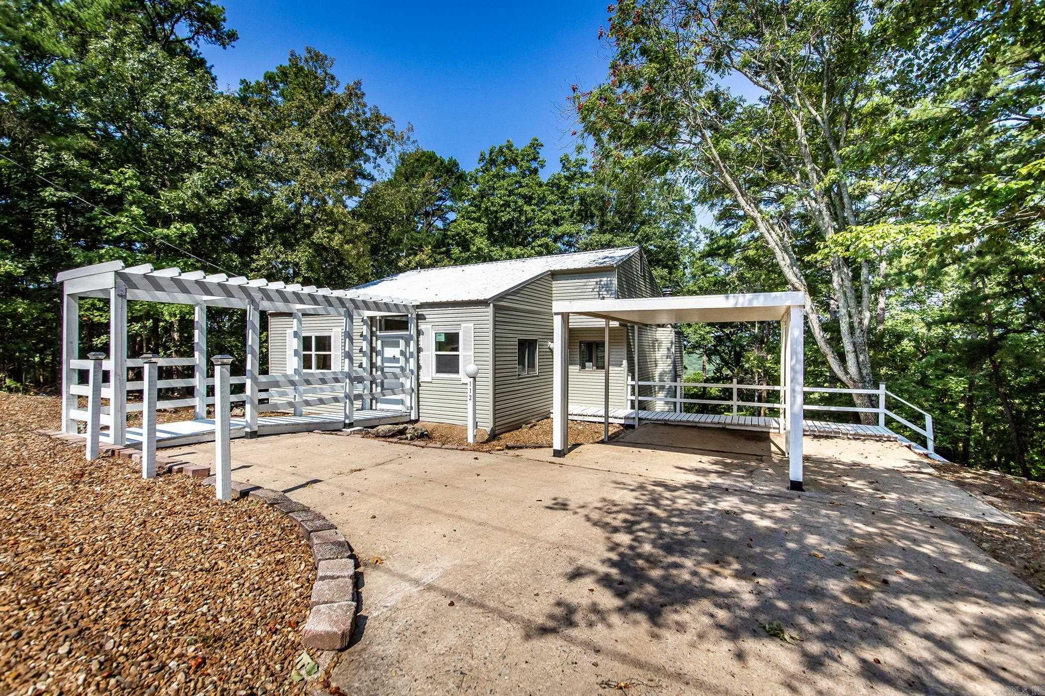 Welcome home in the serene & scenic community of Fairfield Bay, Arkansas! Nestled on a tranquil street where neighbors take leisurely walks & savor the surrounding beauty, this delightful residence offers a perfect blend of comfort & convenience. Just a short 10-minute drive will take you to the stunning Greers Ferry Lake & the beautifully manicured Indian Hills Golf Course & Mountain Ranch Golf Course. Inside, this charming home has undergone recent upgrades to ensure modern living at its finest. Revel in the energy efficiency & bright ambience provided by LED lighting throughout the house. The new deck offers a serene spot to relax & take in the natural beauty of the Bay. The kitchen is equipped with sleek stainless steel appliances, perfect for cooking gourmet meals. Other improvements include updated toilets & luxury vinyl flooring in select areas for added elegance & easy maintenance. Stay comfortable year-round with the new heat and air system. The Bay boasts an impressive list of amenities that cater to all interests & ages, including three inviting swimming pools, a fun-filled putt-putt golf, pickle ball & tennis courts. Owner will finance for two years. 5.5% WAC