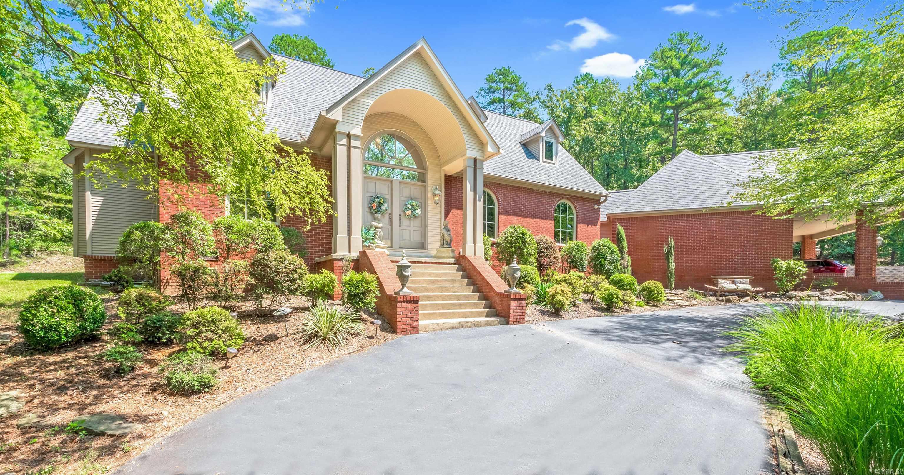 Take the gated driveway up to this country estate and enjoy the circle drive featuring a beautiful pond with water flowing on cascading rocks. Enjoy your on oasis with over 3 wooded acres. Looking further you will find a spa like landscaped pool with another waterfall feature just steps away from your back door. Attached 4 car carport located at the back of the home. Large 2000 sq. ft. metal shop building with room for all of your toys just past the pool. Home features 4 Bedrooms/3.5 Baths and the master bedroom is on the main level with a beautiful bathroom and jetted tub. The remainder of this home features formal dining, eat-in kitchen, living room, an office, and a game room not to mention the large laundry room with sink. A patio/deck off the kitchen for entertaining. A must see!