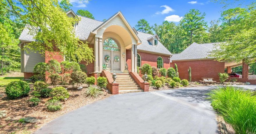 Take the gated driveway up to this country estate and enjoy the circle drive featuring a beautiful pond with water flowing on cascading rocks. Enjoy your on oasis with over 3 wooded acres.  Looking further you will find a spa like landscaped pool with another waterfall feature just steps away from your back door. Attached 4 car carport located at the back of the home. Large 2000 sq. ft. metal shop building with room for all of your toys just past the pool. Home features 4 Bedrooms/3.5 Baths and the master bedroom is on the main level with a beautiful bathroom and jetted tub.  The remainder of this home features formal dining, eat-in kitchen, living room, an office, and a game room not to mention the large laundry room with sink.  A patio/deck off the kitchen for entertaining.  A must see!