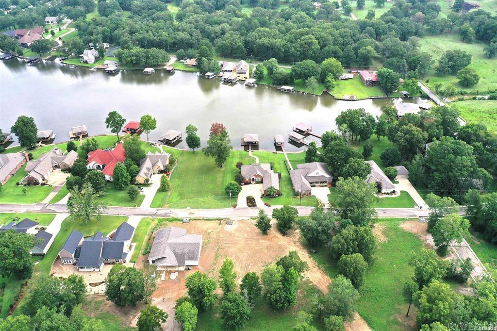 Discover a rare opportunity to own a prime building lot nestled in an exclusive gated subdivision just moments from the enchanting Garvan Woodland Gardens. This generously sized parcel offers the perfect blend of natural serenity and modern convenience. Lake Access Park: Enjoy private access to a well-maintained lakefront park on shimmering Lake Hamiltonāideal for picnics, kayaking, or sunset strolls. Modern Infrastructure: Equipped with all utilitiesāwater, sewer, electricity, and moreāready for your custom home to rise without delay. Pristine Roadways: Freshly paved blacktop streets with elegant curb and gutter design throughout the community. Stunning Vistas: Elevated views of Lake Hamilton offer a picturesque backdrop for daily living and entertaining. Whether you're looking to build a year-round residence or a weekend getaway, this tranquil lot provides a harmonious balance of privacy, nature, and accessibility.