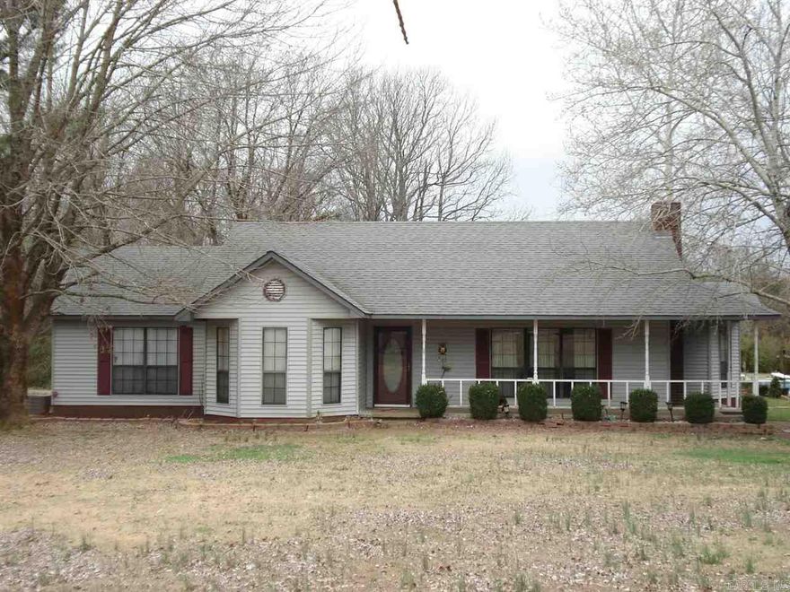 Quite country living just minutes from Wal-Mart! Charming home and almost 15 acres of land with an in-ground pool!