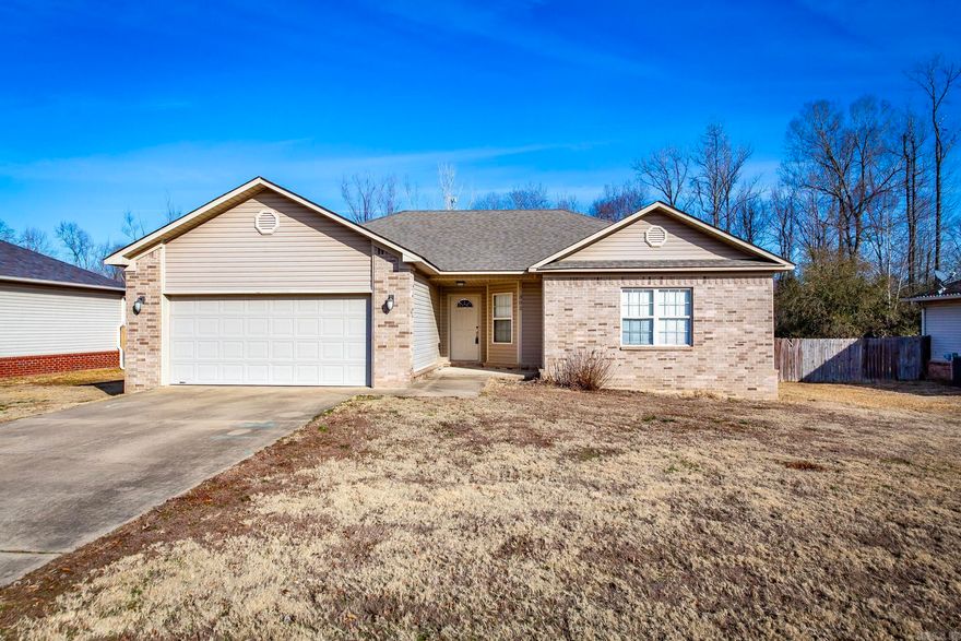 This beautifully maintained home features a thoughtful split floor plan, offering both privacy and space for everyone. The expansive, open layout is perfect for entertaining, with a vaulted ceiling in the living room and large windows that flood the space with natural light. The modern kitchen boasts a breakfast bar and sleek stainless steel appliances, making cooking and hosting a joy. Retreat to the luxurious master bathroom, complete with a double sink vanity, a jetted tub, a spacious separate shower, and his-and-hers closets for added convenience. The home is finished with stylish Pergo flooring and tile throughout, ensuring no carpet to maintain. Enjoy the ease of a separate laundry room and the privacy of a serene backyard with a deck—ideal for outdoor relaxation or entertaining.