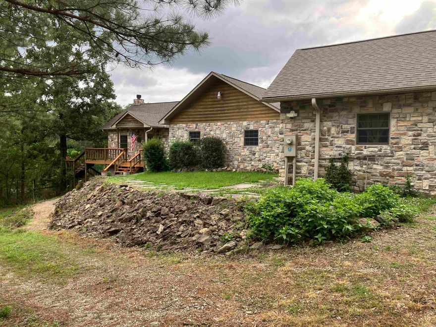 Lake living in a country setting. Are you looking for a lake front home but you don’t want the noise and traffic associated with the cramped neighborhoods on Lake Hamilton. Situated on 2.25 acres on the upper end of Lake Catherine with 210 feet of lake frontage and a boardwalk,  this property has 3 beds, 2 baths in the main house and living quarters in the garage with another bath. Exotic woods, granite, Delta fixtures, and Anderson windows are used throughout the house. Tongue and groove cathedral ceiling and Brazilian walnut floors, mahogany bar and African rosewood mantle and fireplace create a warm soothing atmosphere. Walk-in closets and lots of cabinets in the laundry room provides tons of storage. Outdoor living area features a 18x36 swimming pool, gazebo, bar and spacious decks all around the house. The 3 car garage and house are covered completely in centurion stone with log siding eaves. There is a 300sqft finished basement and a 12x12 storage building near the lake to store your toys. This custom house has everything a person could want. Come take a look and fall in love.