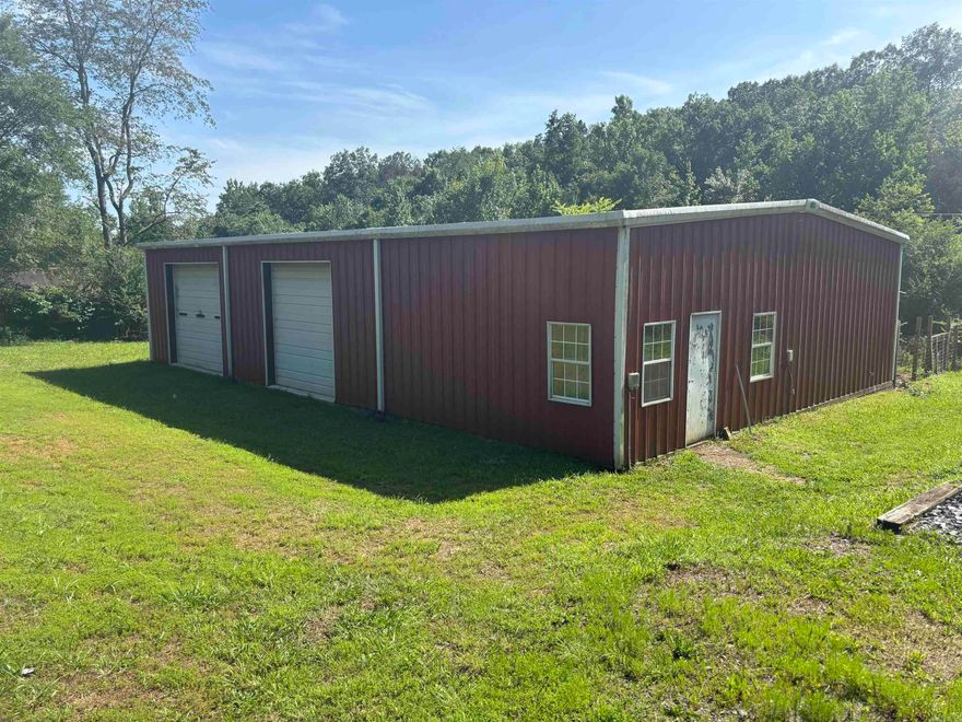 This nice metal building with living quarters and plenty of room to expand sits on approx. 1.58 acres. There are 2 bedrooms, 1 bathroom, and a large laundry room, all featuring wood paneling and laminate flooring. Appliances convey. The 1440 sq ft shop space has two bays, and the all-electric shop and living quarters total 2400 sq ft.