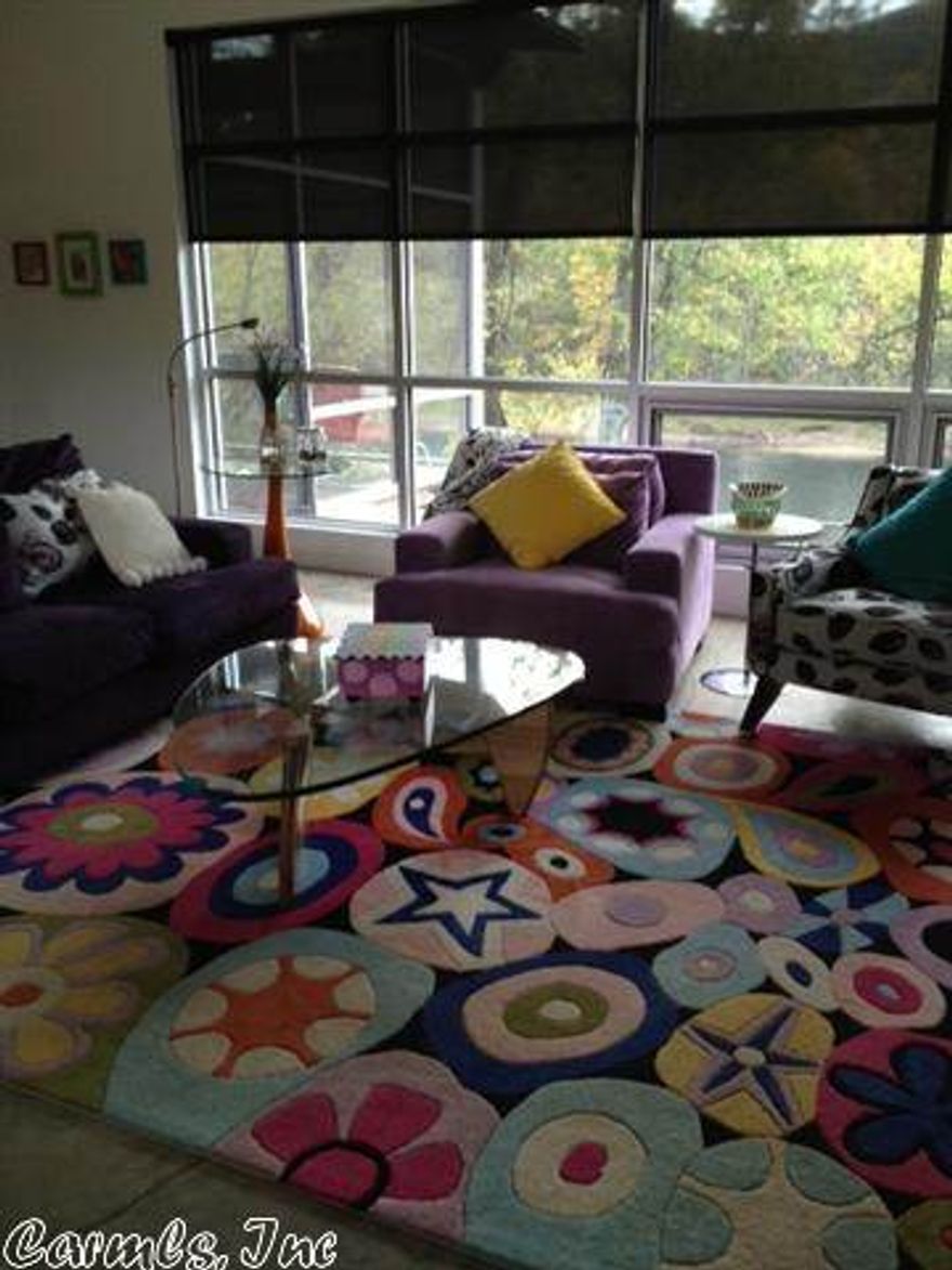 This is a beautiful contemporary home in Primrose Creek overlooking the Little Red River.  New home built in 2008 with all the amenities.  Open floor plan with breathtaking views of the river. This home has beautiful stainless appliances and countertops.  Recessed and track lighting with beautiful concrete floors.  This home has an unbelievable screened in porch overhanging the river! Homeowners just built a new dock with a boat slip!  This is a must see!