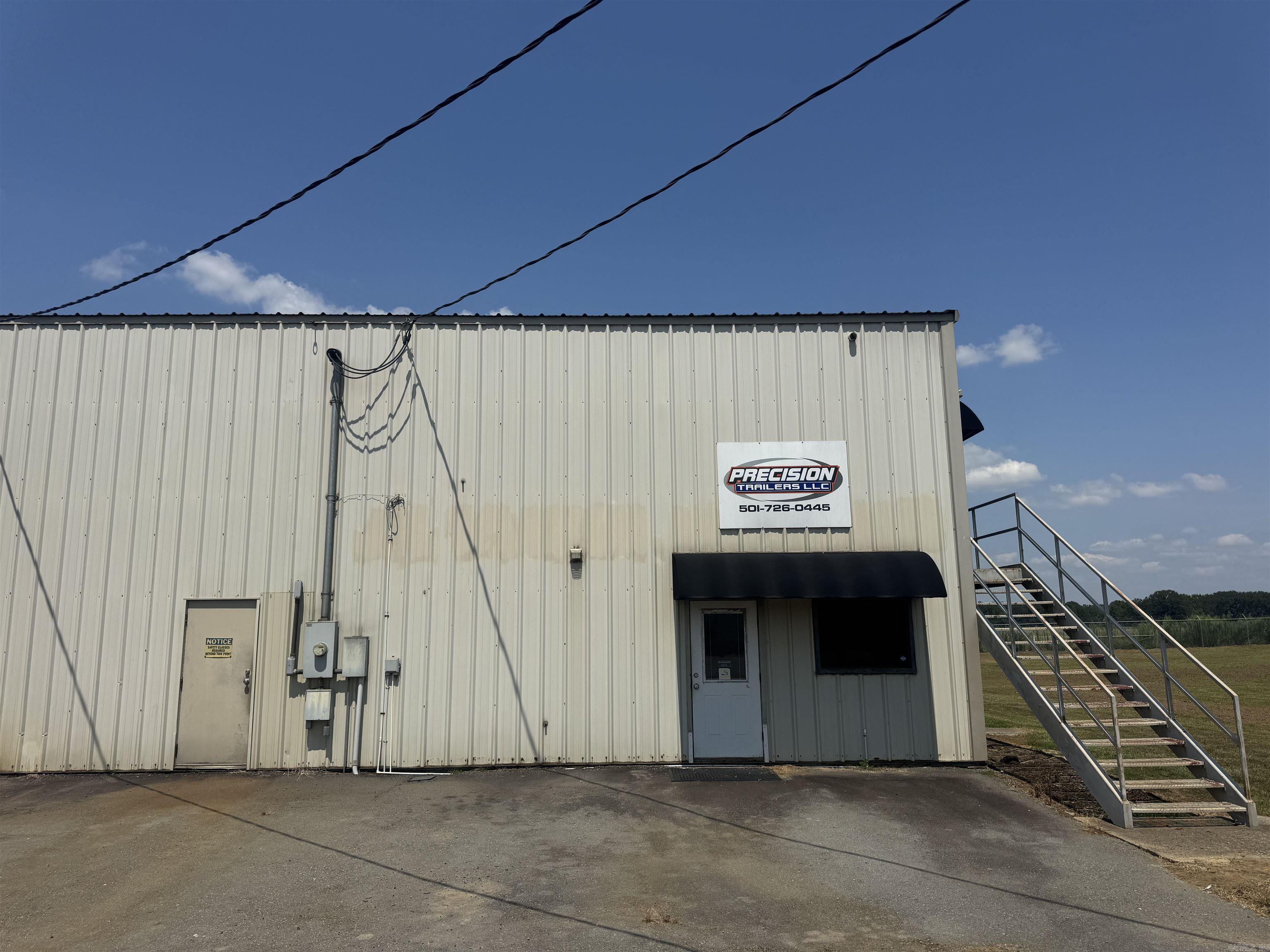 Looking to grow your business? This space has it all with plenty of room to expand! Over 750 foot of Freeway frontage and 7.5+/- acres fully fenced warehouse/manufacturing space. Over 8500 square foot warehouse space and another 750sq ft heated and cooled with offices/ bathrooms down stairs. There is also a nice 2 bedroom apartment upstairs with 2 full baths and kitchen thats a huge bonus! 5,000 square feet of covered awning for material handling as well! This space was designed with heavy machinery in mind! Main warehouse features a heavy duty crane, vented paint bay, 440 3 phase service with 220 power and air connections ran throughout. 3 power overhead door with 20+ foot ceilings with updated LED lighting as well. There is a total of 3 buildings with 2 separate warehouses and a newly built storage building constructed in 2024. This opportunity doesn't show up often with everything that's included in this package deal!