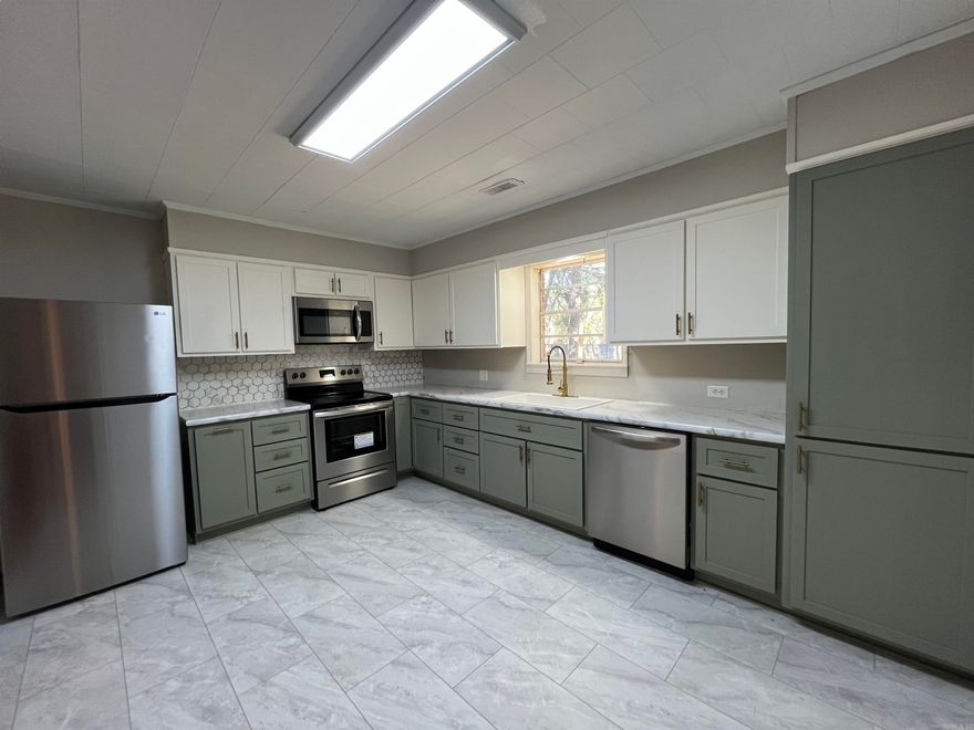 Did the kitchen catch your eye? It's just one of many things to love about this beautifully updated 3 bedroom, 1 bath. Ready for its new owner, the fully remodeled kitchen is a true showstopper, featuring a stylish blend of sage and white cabinets, gold accents, and a stunning backsplash. The bathroom has also been thoughtfully updated, complete with a dimmable, fog-resistant mirror with touch activation for a spa-like experience. New carpet adds comfort to the bedrooms, while the original hardwood floors bring warmth and character to the living areas. The sleek, marble look tile in both the kitchen and bathroom adds a modern touch. The primary bedroom stands out with its eye catching accent wall, creating a cozy retreat. Outside, the large, fully fenced backyard offers a perfect space to relax or entertain, complete with a fire pit area and a storage shed. All new kitchen appliances, including the refrigerator, as well as the gently used washer and dryer, are included. With gas heat and a gas water heater, this move-in-ready home is as efficient as it is beautiful. Don’t miss out on this gem — it’s waiting for you!