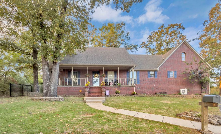 Graceful design, modern comfort, and the perfect location - all in one address. This gorgeous brick facade home is perfectly perched at the end of a quiet cul-de-sac that is steps away from the greens of the Morrilton Country Club. The welcoming, covered front porch begs you to stop and stay awhile before you step inside. Step through the front door into a bright, inviting living space that flows effortlessly into the open kitchen and dining area, perfect for entertaining. The kitchen is a chef's delight, featuring stainless steel appliances, granite countertops, and a butcher block island. But the fun doesn't stop inside, outside the backyard is a true oasis, where a covered patio is waiting to be filled with laughter, memories, and the smell of BBQ on the weekends as you watch the big game. Stunning landscaping leads to a cozy fire pit, where you can sit back and relax as you take in your new life. The converted garage adds incredible versatility, currently used as a home gym, but easily adaptable to a media room, studio, or home office. Back inside, once the day is gone, head upstairs to the spacious bedroom suite, complete with its own living area and full bathroom.