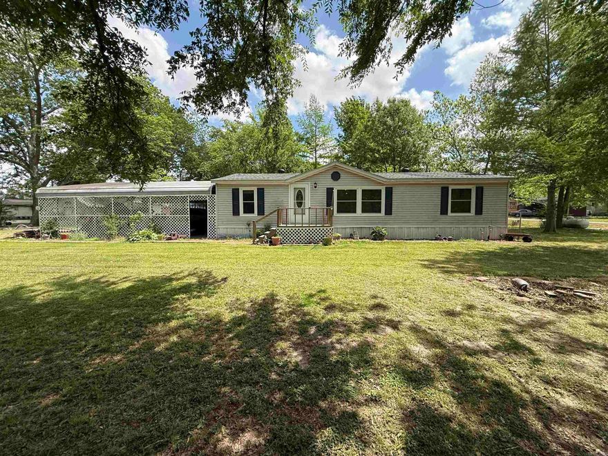 This country home, situated on nearly half an acre, has it all.  Highlights include a whole-home Generac generator, a wheelchair ramp, a screened-in back porch, an extended mudroom, a to-die-for pantry, and three storage sheds—one equipped with both 110 and 220 hookups. Additionally, there is a metal carport that accommodates up to six vehicles. The kitchen and both bathrooms have been updated, complemented by new flooring throughout. Seller put on a new roof, updated windows, doors, lighting fixtures, and ceiling fans.  Location would make the perfect hunting cabin or a permanent residence. Home is NOT in the flood zone, and flood insurance is not required.