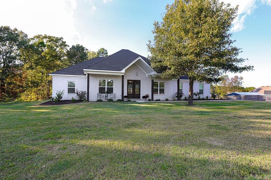 This one is a BEAUTY!!  Located on OVER AN ACRE with that "in the country" feel, this 4 bedroom/2 bath home is convenient to all of Saline County and Little Rock!  It boasts an open floor plan with large kitchen island that everyone loves!  The spacious living area features a gorgeous wood burning fireplace with a fantastic brick hearth! The kitchen is complete with the large island (suitable for about 4 bar stools), a walk-in pantry, wall oven, surface stove, and eat-in breakfast area!  There is also a separate formal dining room! The wood floors in the main areas of the house are gorgeous and easy to care for!  The Primary Bedroom is split from the others, and it has a soaker tub, a custom tile walk-in shower, and a great closet that connects to the laundry room!  The entire property is fenced; there's a beautiful iron entry gate, and there's plenty of parking for all of your friends and family!  Agents see remarks!