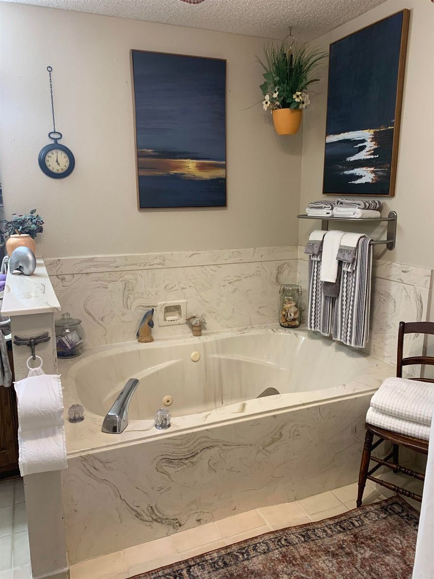 All-brick 2BD/2BA home in a quiet, wooded setting just minutes from shopping and amenities. Major updates in the last two years include new architectural-shingle roof, new gutters, new HVAC, new hot water heater, new carpet in bedrooms, new light fixtures throughout, new storm doors, and new kitchen appliances. Bright interior with skylight, built-ins in the living room, and a flexible sunroom with private carport entry—ideal for a 3rd bedroom, office, or hobby space. Primary suite offers two walk-in closets and a custom curb less walk-in shower. Large deck and gazebo overlook common property for added privacy. Abundant storage plus carport with storage room. $2,000 one-time buy-in fee due at closing. AGENTS SEE COMMENTS!