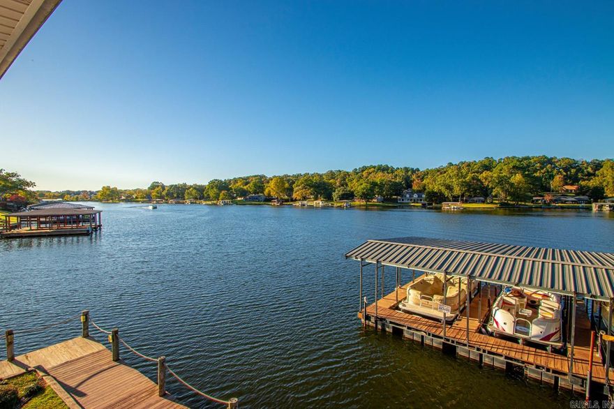 4 bedroom, 4 bath condo on Lake Hamilton in a gated neighborhood. It is off Central, minutes to Oaklawn. It has an open floor plan with two bedrooms downstairs and two large bedrooms upstairs with a balcony looking over the water. It features 9 ft ceilings, a fireplace, granite, and a large private covered deck with a one car garage. Complex has pool, hot tub, and large field.  Call to see it today!