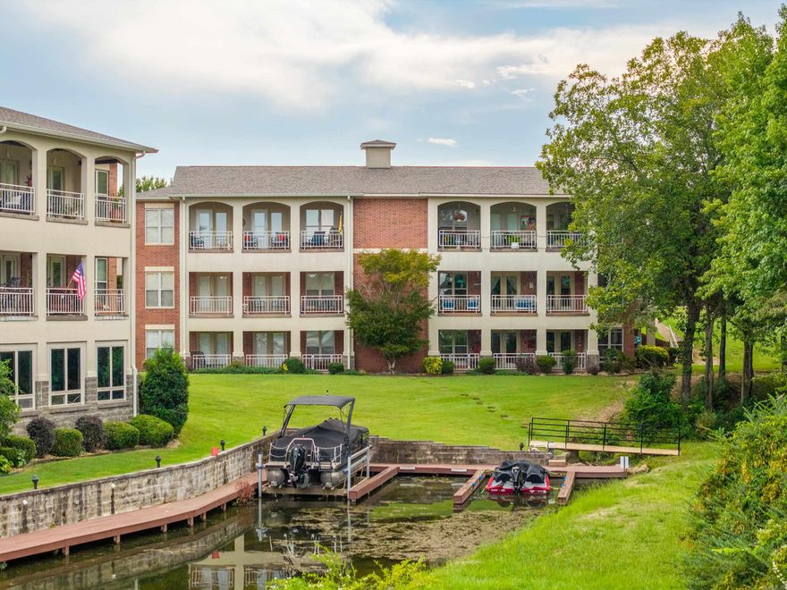 This rare and unique Millennium Bay beauty has extras upon extras leaving no amenity unturned!  Boasting 3,440 square feet, this spacious two-level unit is like having two condos in one.  The upper level is conveniently walk-in, open concept living, and includes a primary suite and a guest room and guest bath.  Downstairs opens up into another open concept living space with another full kitchen, two bedrooms and one and a half baths.  Both levels also have two balconies to enjoy the peaceful setting and of course lake views.  The lower level also has it's own exterior entrance making this a great opportunity for an in-law's quarters, large family, or if you just want extra space to entertain your guests!  You also have the ability to lease the units separately making this also an income opportunity.  This unit also comes with a boat slip!  Enjoy the beautiful pool & picnic areas, gorgeous grounds, and the convenience of the community boat ramp.  Unit U1 is also located at the end of the cove and the perimeter of the complex that gives added privacy by bordering a wooded area.  Aside from the one car garage, U1 also has three additional parking pads.  Must see!  Call today!