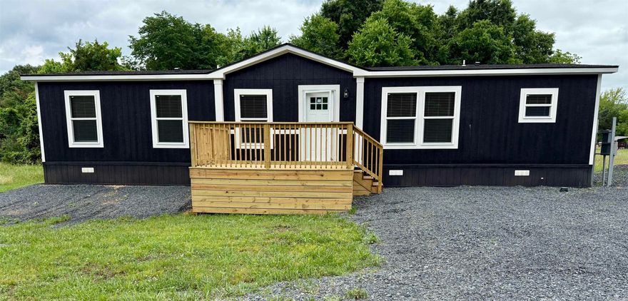 2025 model 3 bedroom, 2 bathroom manufactured home offering approximately 1,568 sq ft with bold modern farmhouse styling throughout. This beautifully finished home features black accent trim, custom feature wall, sliding barn door, recessed lighting, and an open concept floor plan designed for both comfort and entertaining. The spacious kitchen includes stainless steel appliances, oversized island seating, abundant cabinetry, and striking black-and-white finishes. Split bedroom layout provides privacy, while the primary suite offers a walk-in closet and private bath. Permanently affixed to the ground on a concrete slab, making it eligible for government financing per engineering certification requirements. Move-in ready with modern style and functionality throughout. See documents on file for a copy of the Energy Star Certification.